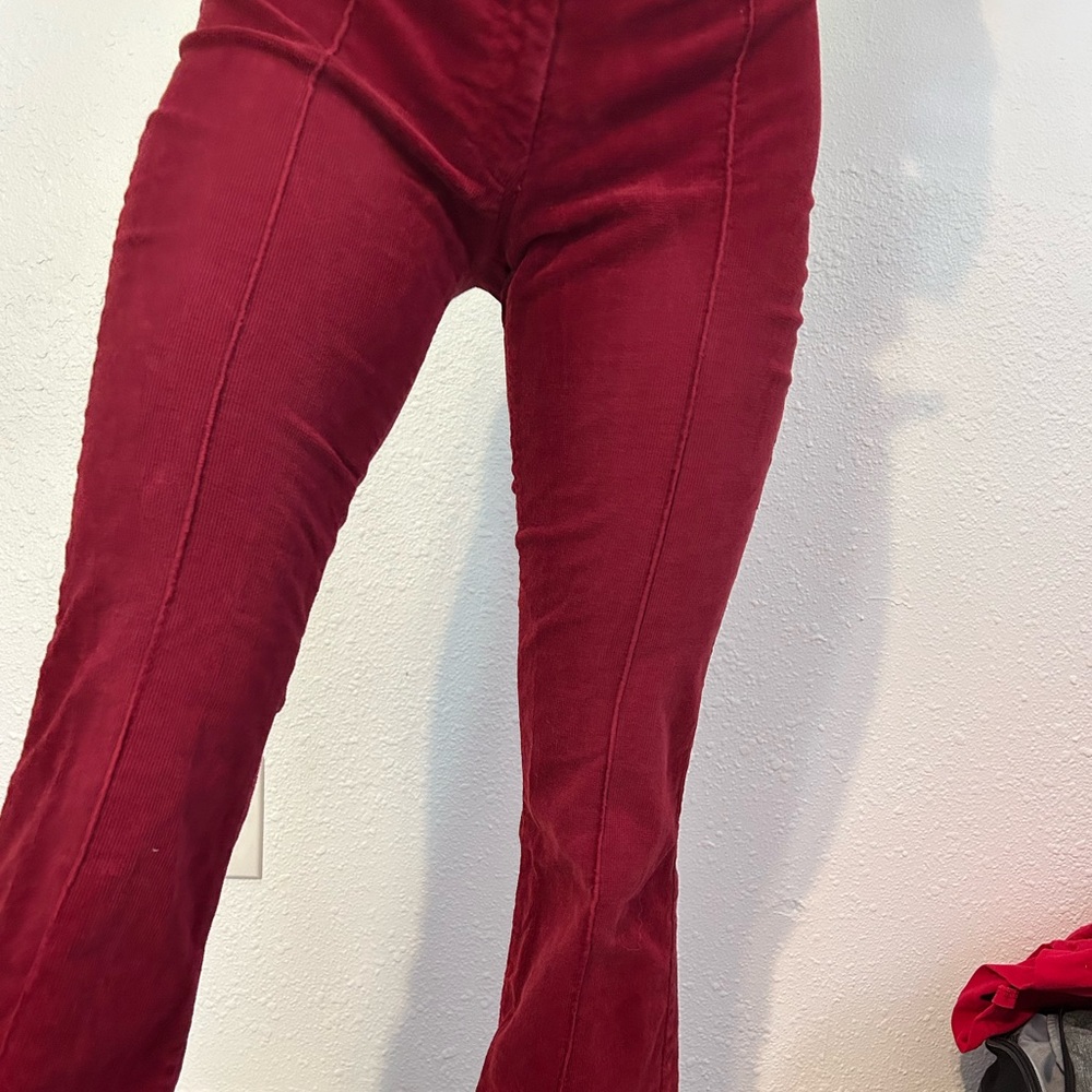 Red corduroy pants with buckles on either side
